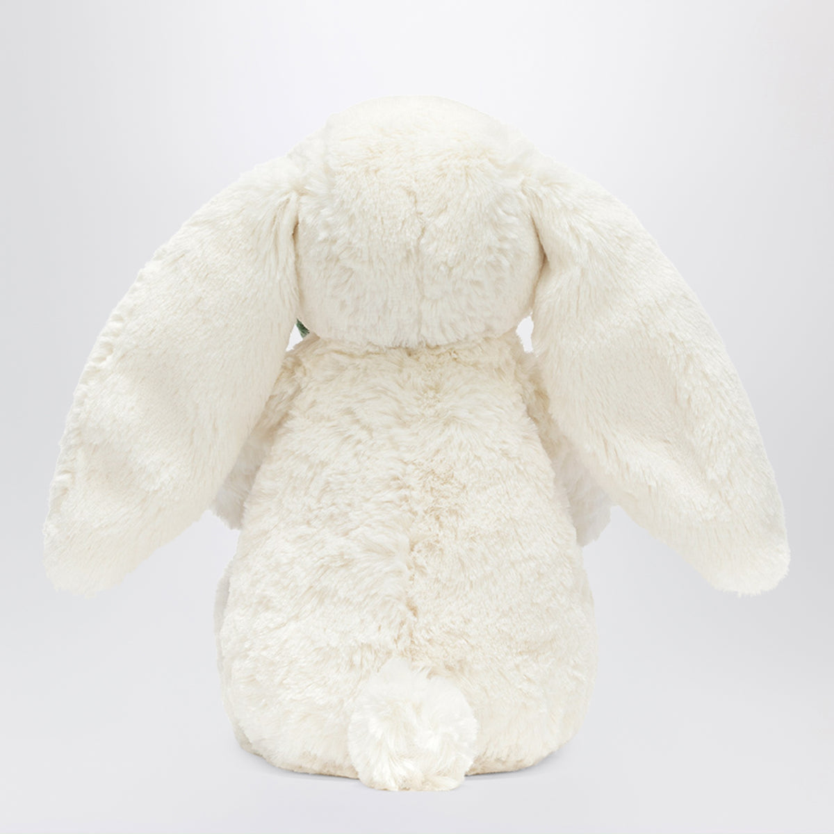 Cremefarbenes Bunny Plüschtier mit Pflanze