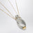 Collana con pendente a bottiglia in ottone oro/argento