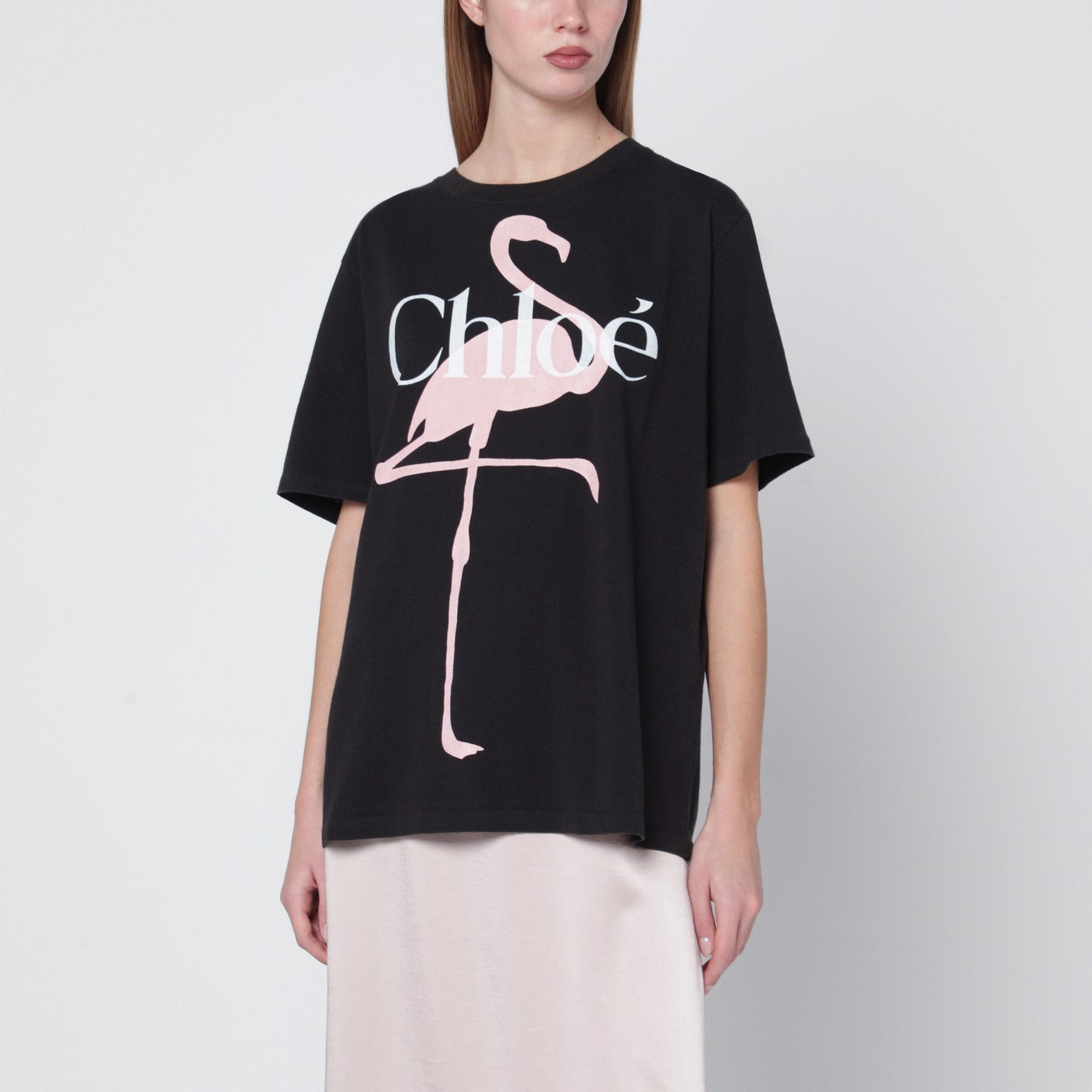 T-shirt ampia nera con logo e stampa fenicottero