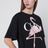 T-shirt ampia nera con logo e stampa fenicottero