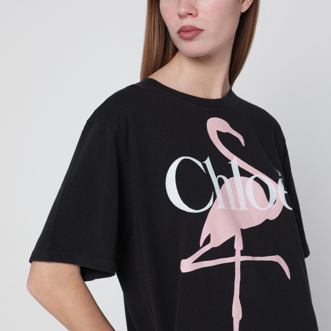 T-shirt ampia nera con logo e stampa fenicottero