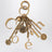 Charm portachiavi Symbols Logo in ottone oro