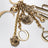 Charm portachiavi Symbols Logo in ottone oro