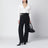 Black trousers with double belt and gold buckles