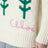Oversized milk-coloured wool sweater with tulips