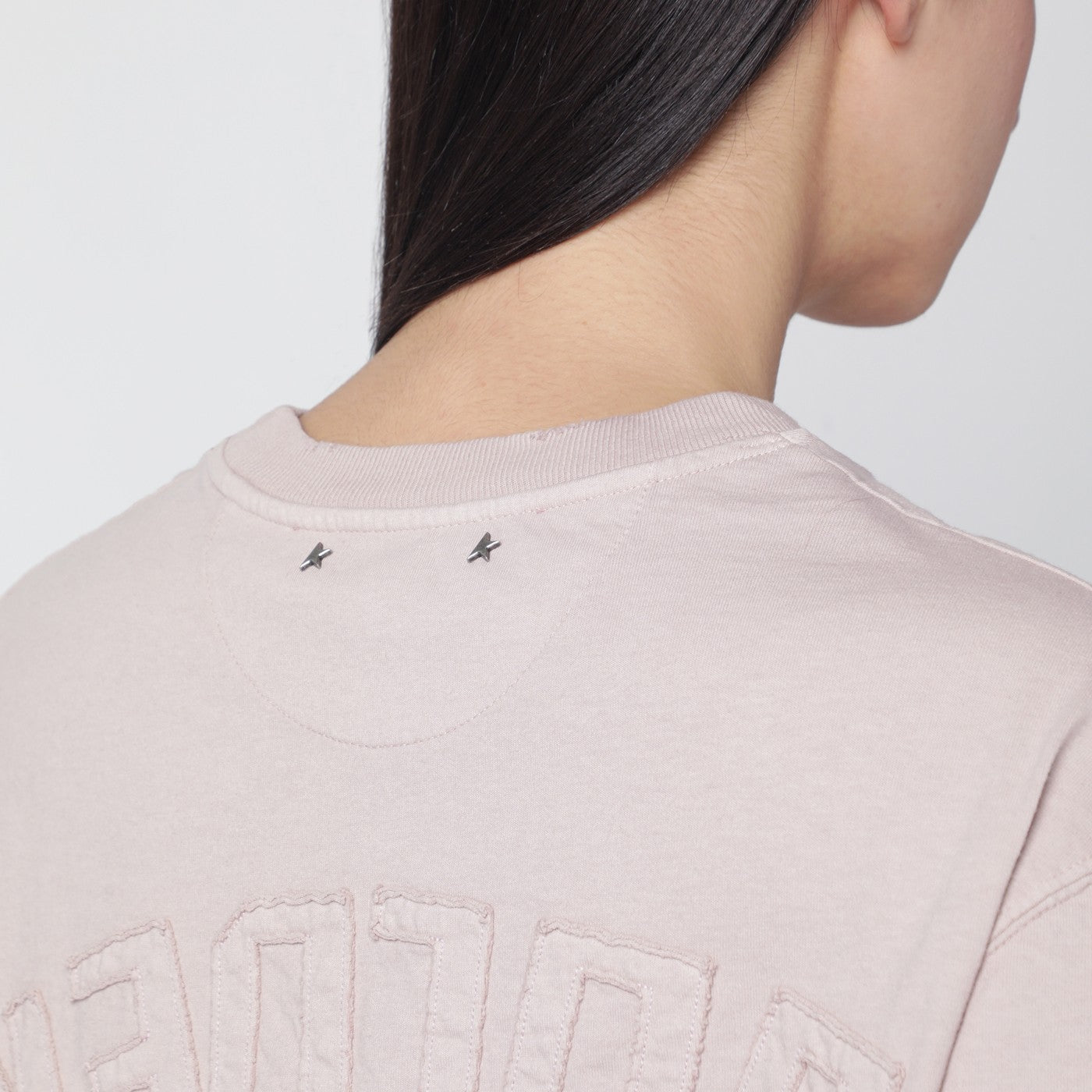Pink T-shirt with reversed logo lettering on the back