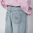 Light blue jeans with logo on the back