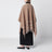 Jacquard poncho with fringes in sand-colored wool