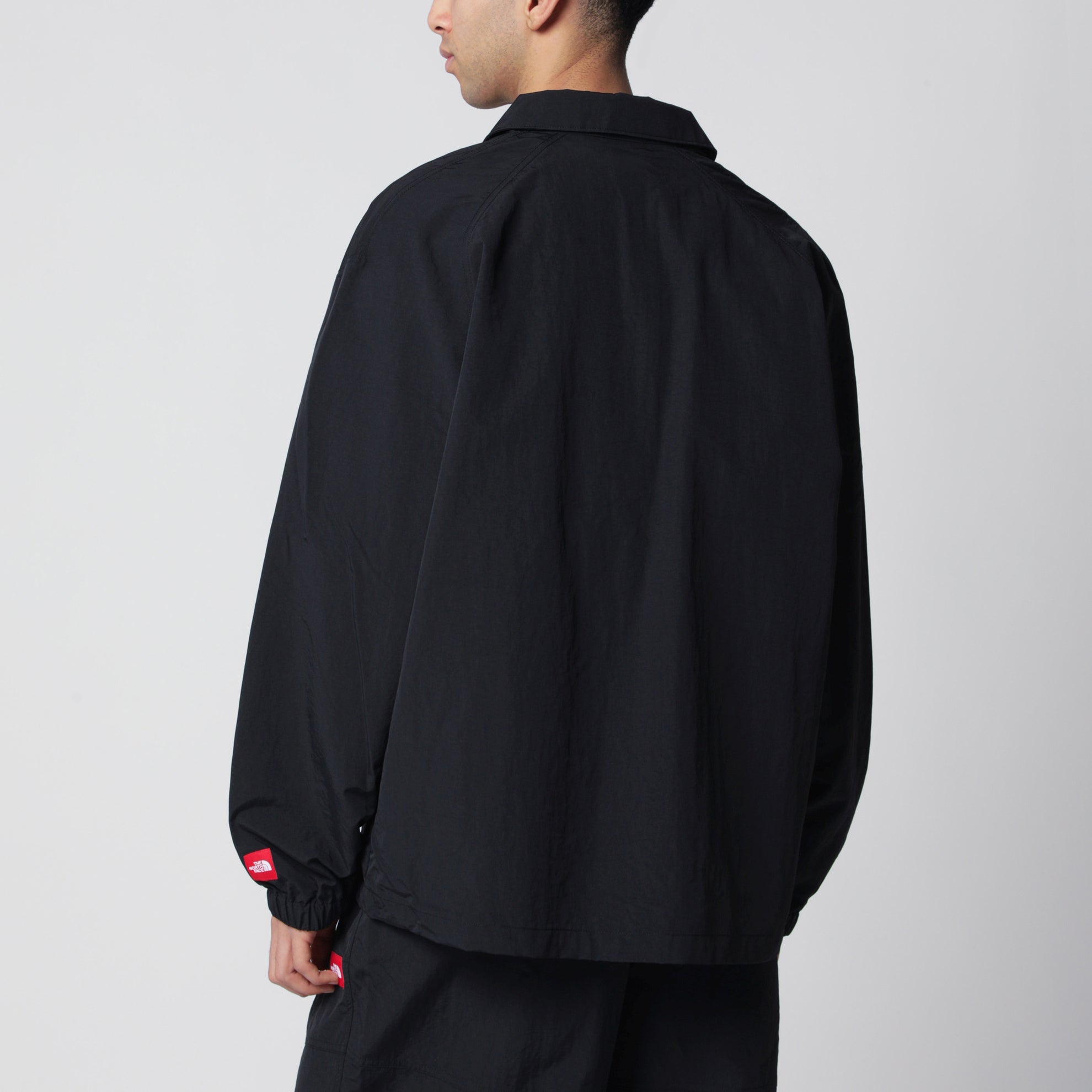 Black zip-up nylon jacket