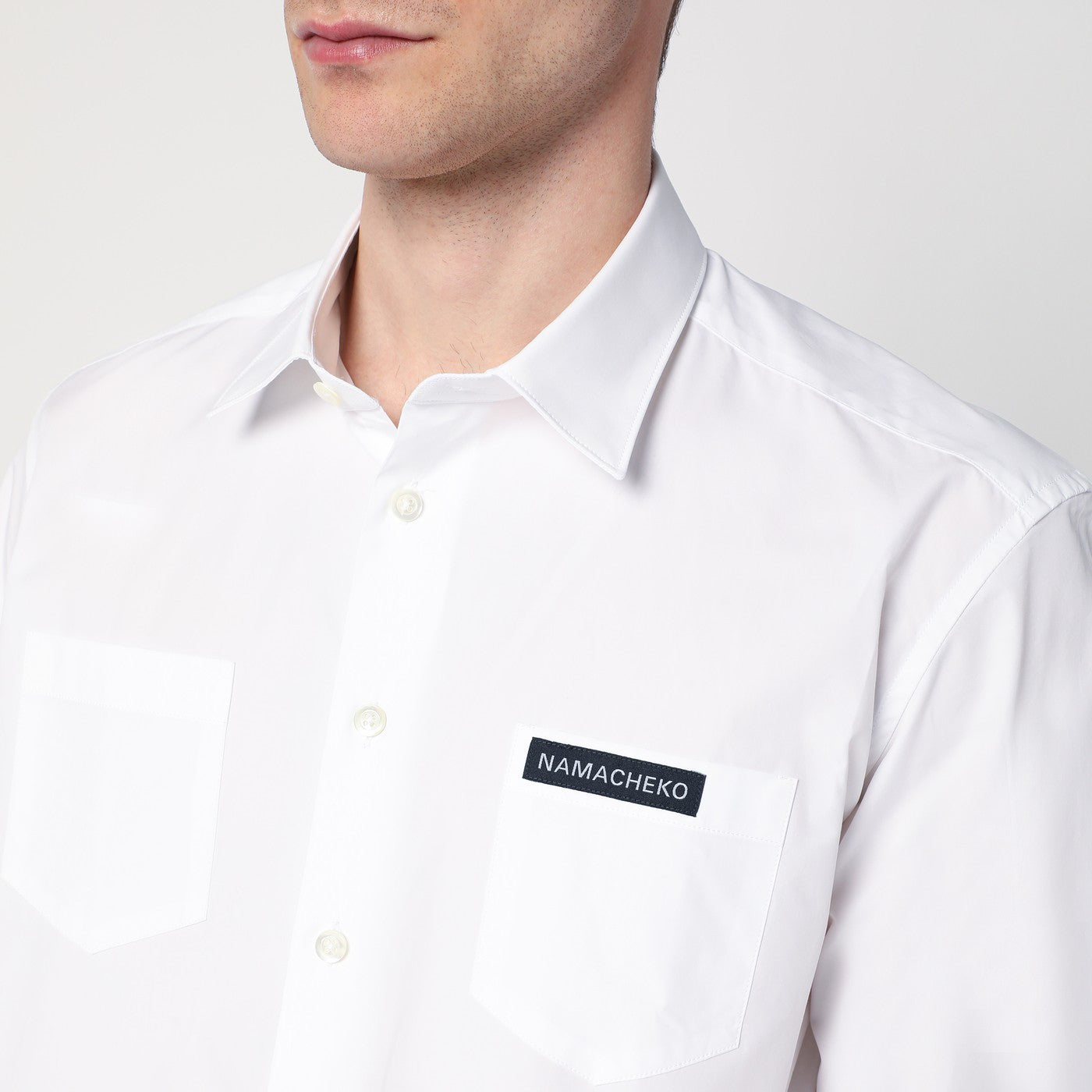White shirt with logo patch