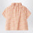 Apricot-coloured top with ruffled collar