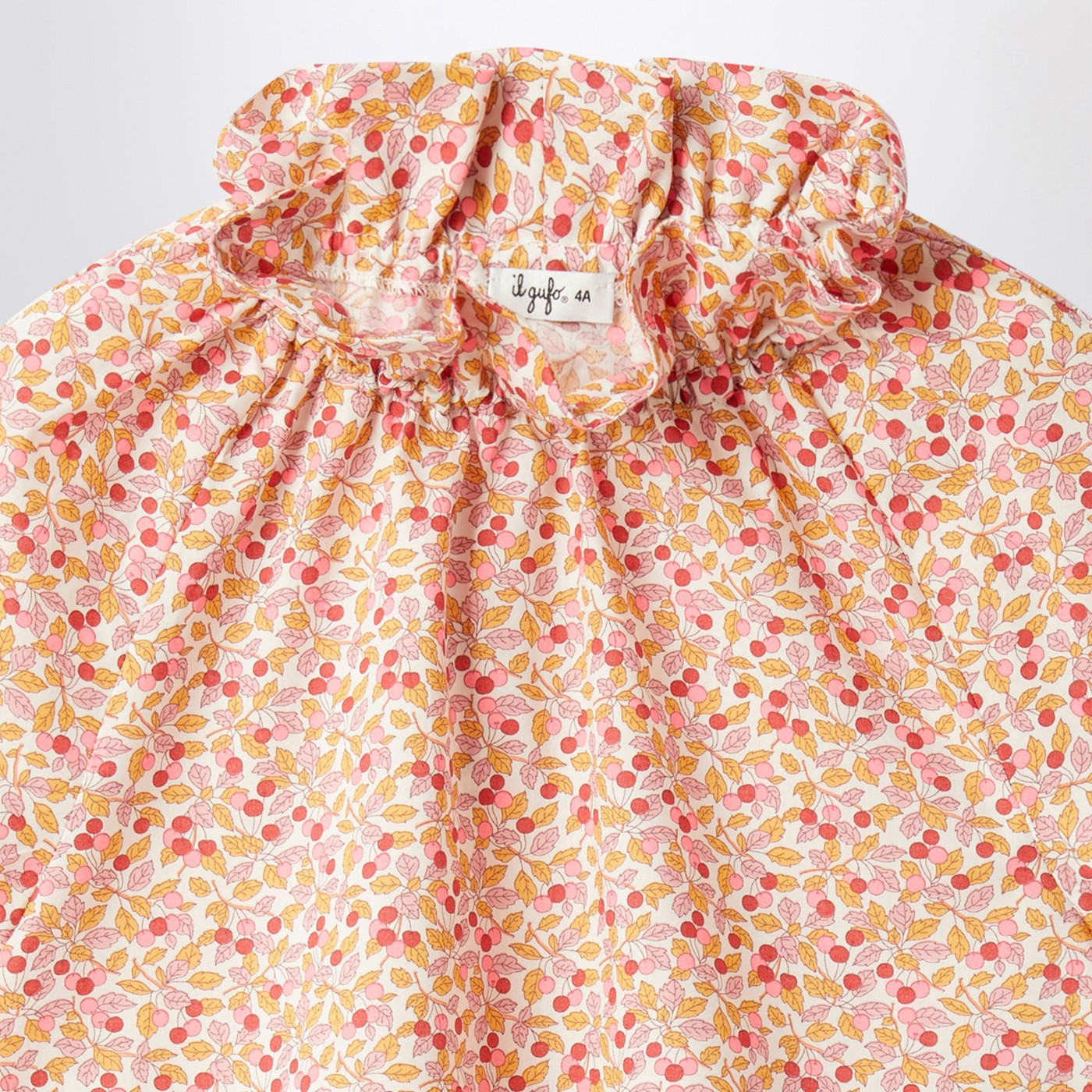 Apricot-coloured top with ruffled collar