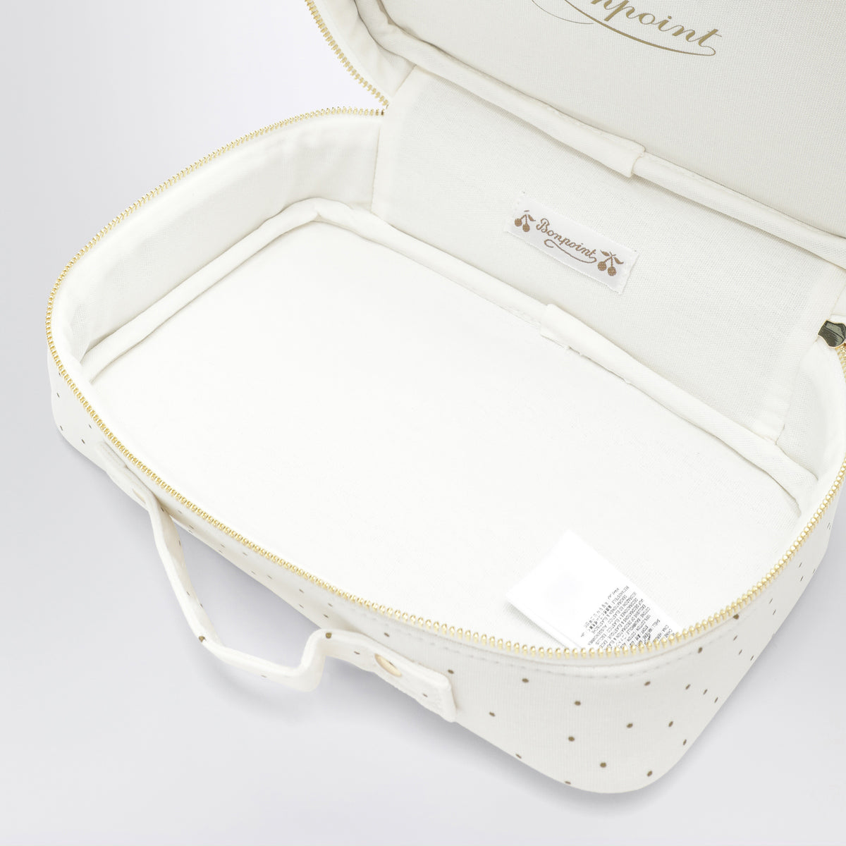 White beauty case with gold polka dots