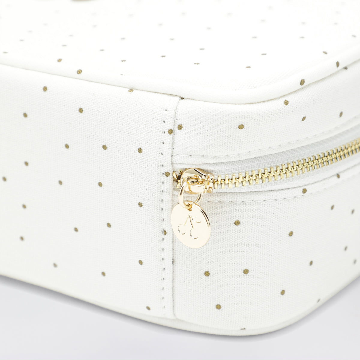 White beauty case with gold polka dots