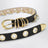 Cintura Revenge nera/oro in pelle con occhielli metallici
