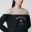 Black top with logo print and sheer insert