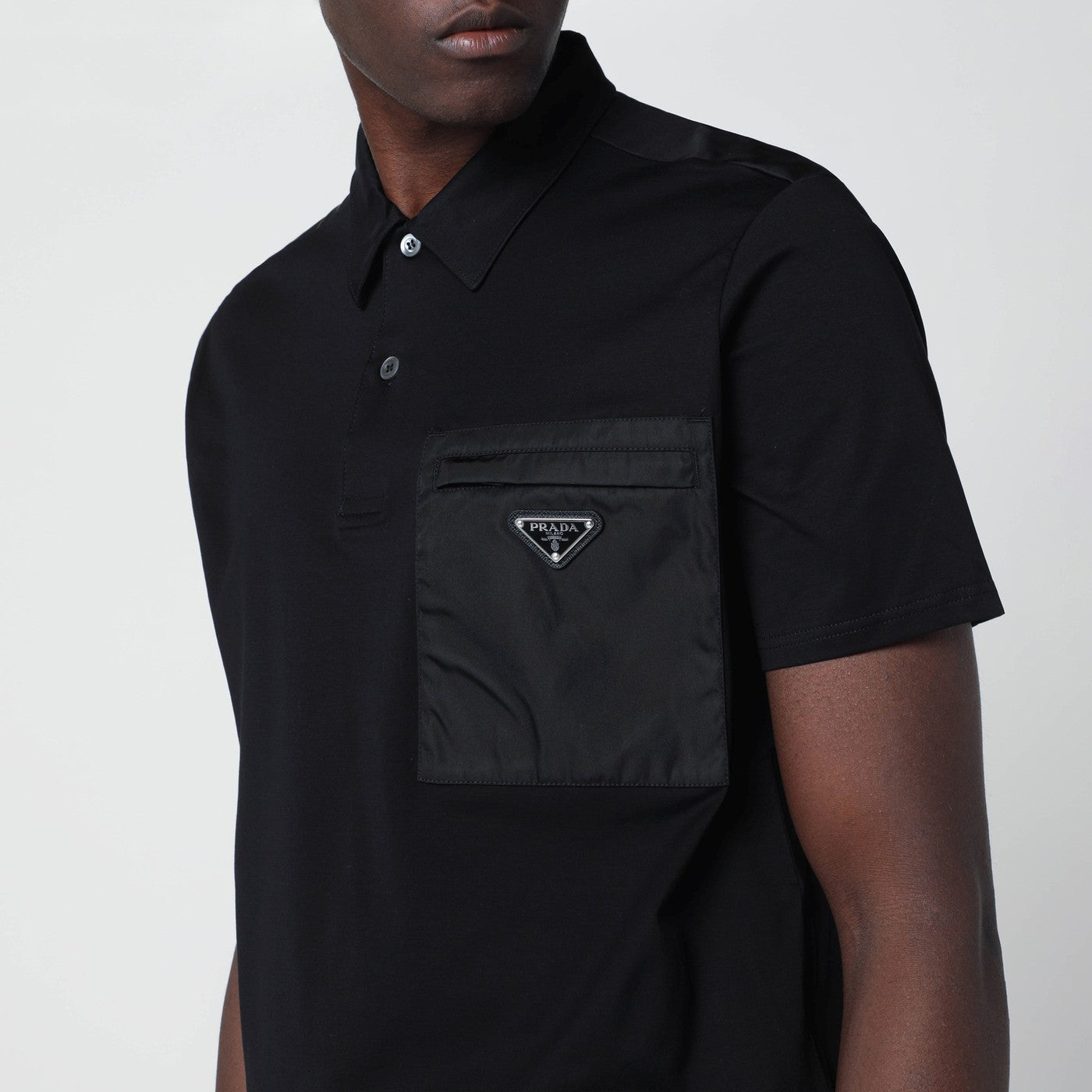 Polo nera in cotone stretch e Re-Nylon